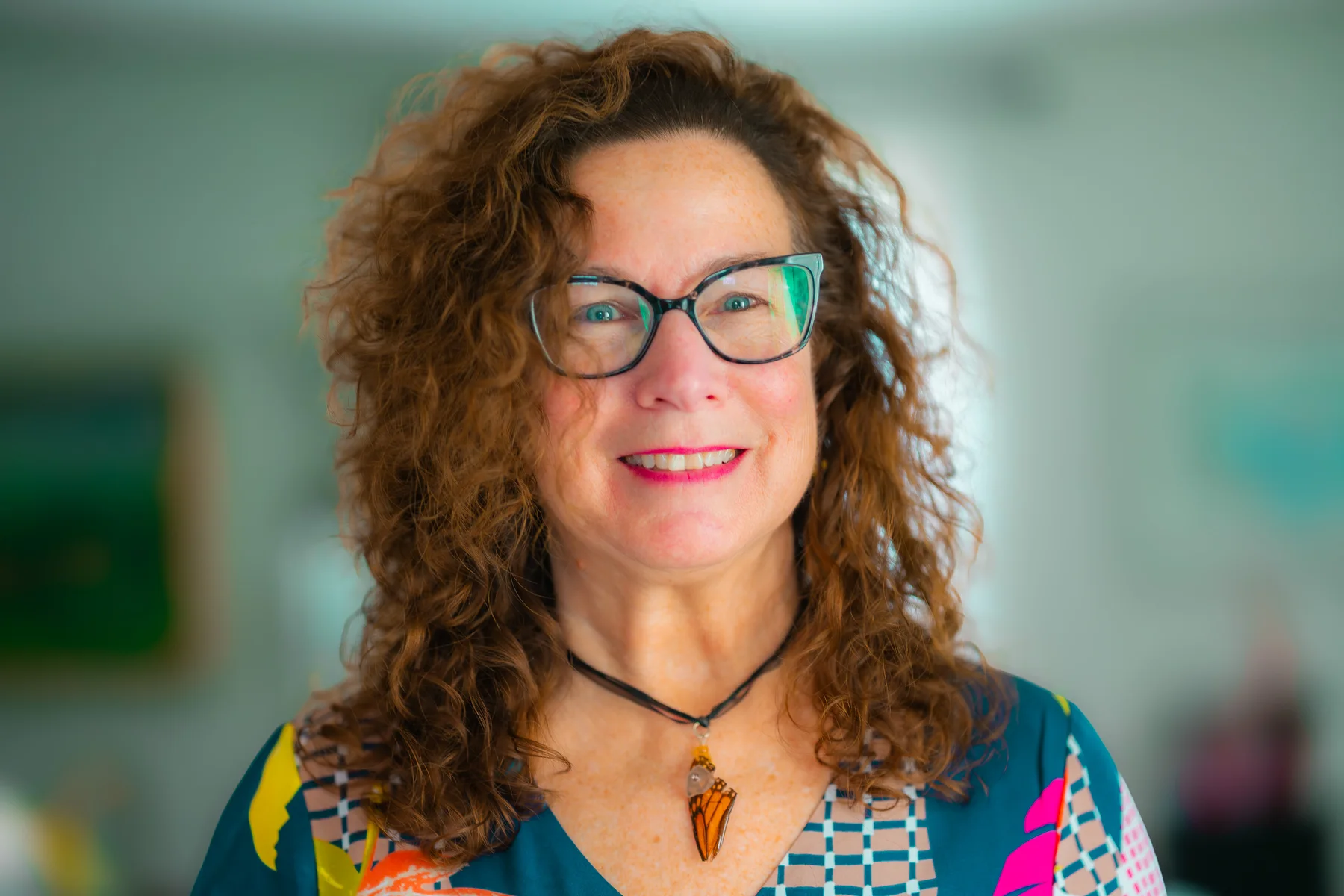 Lizanne Chisholm in a bright professional portrait with a calm expression.